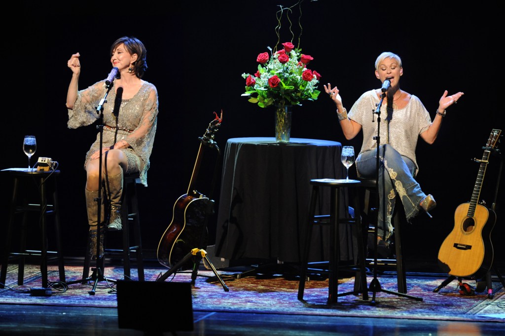 LAS VEGAS - SEPTEMBER 7: In this handout photo provided by the Las Vegas News Bureau, Pam Tillis (l) and Lorrie Morgan (r), both daughters of Country Music Hall of Fame inductees, Mel Tillis and George Morgan respectively, team-up for their Grits and Glamour tour at the Smith Center for the Performing Arts on September 7, 2013 in Las Vegas, Nevada.