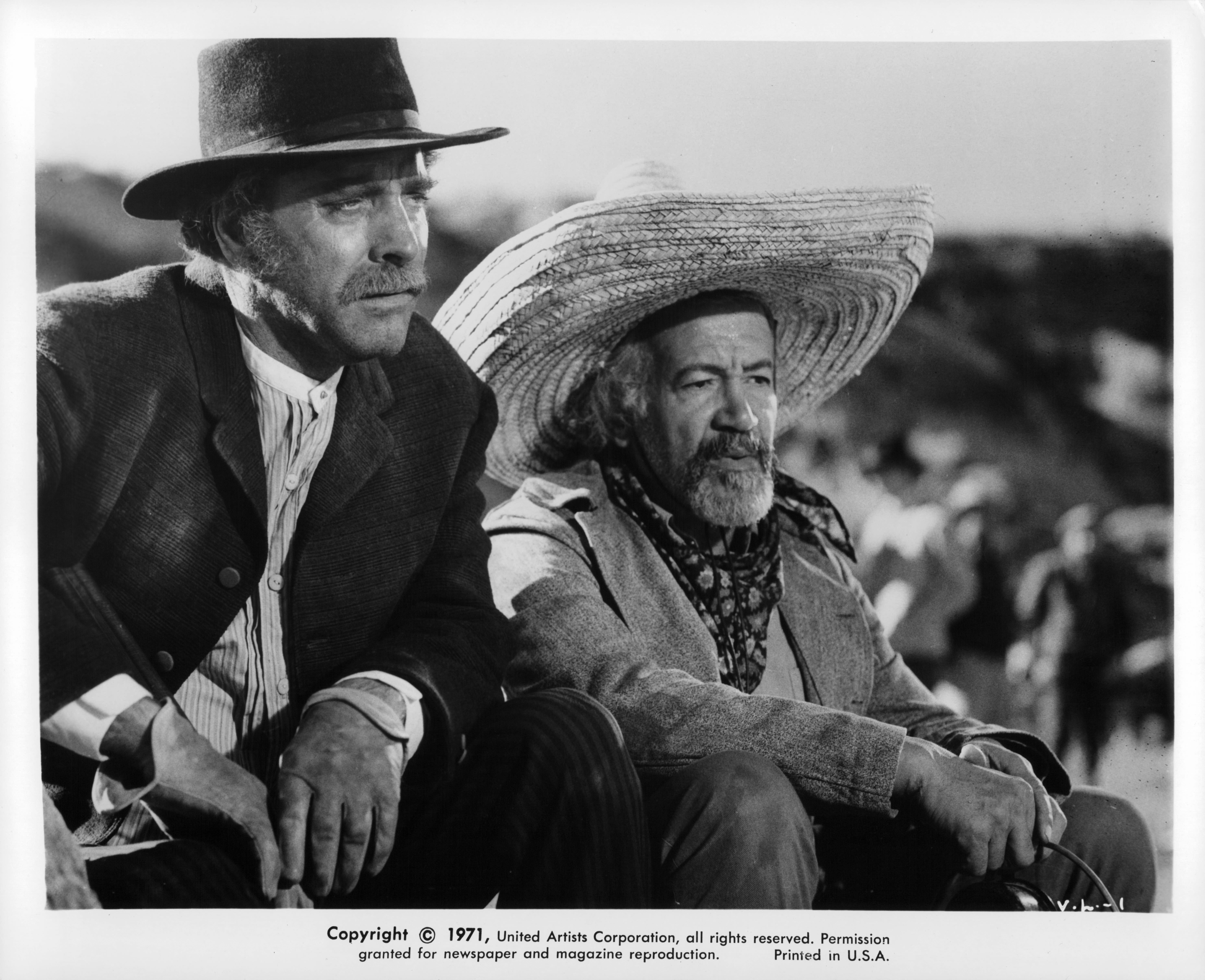 Burt Lancaster and Frank Silvera with hats on, looking out yonder in a scene from the film 'Valdez Is Coming', 1971.