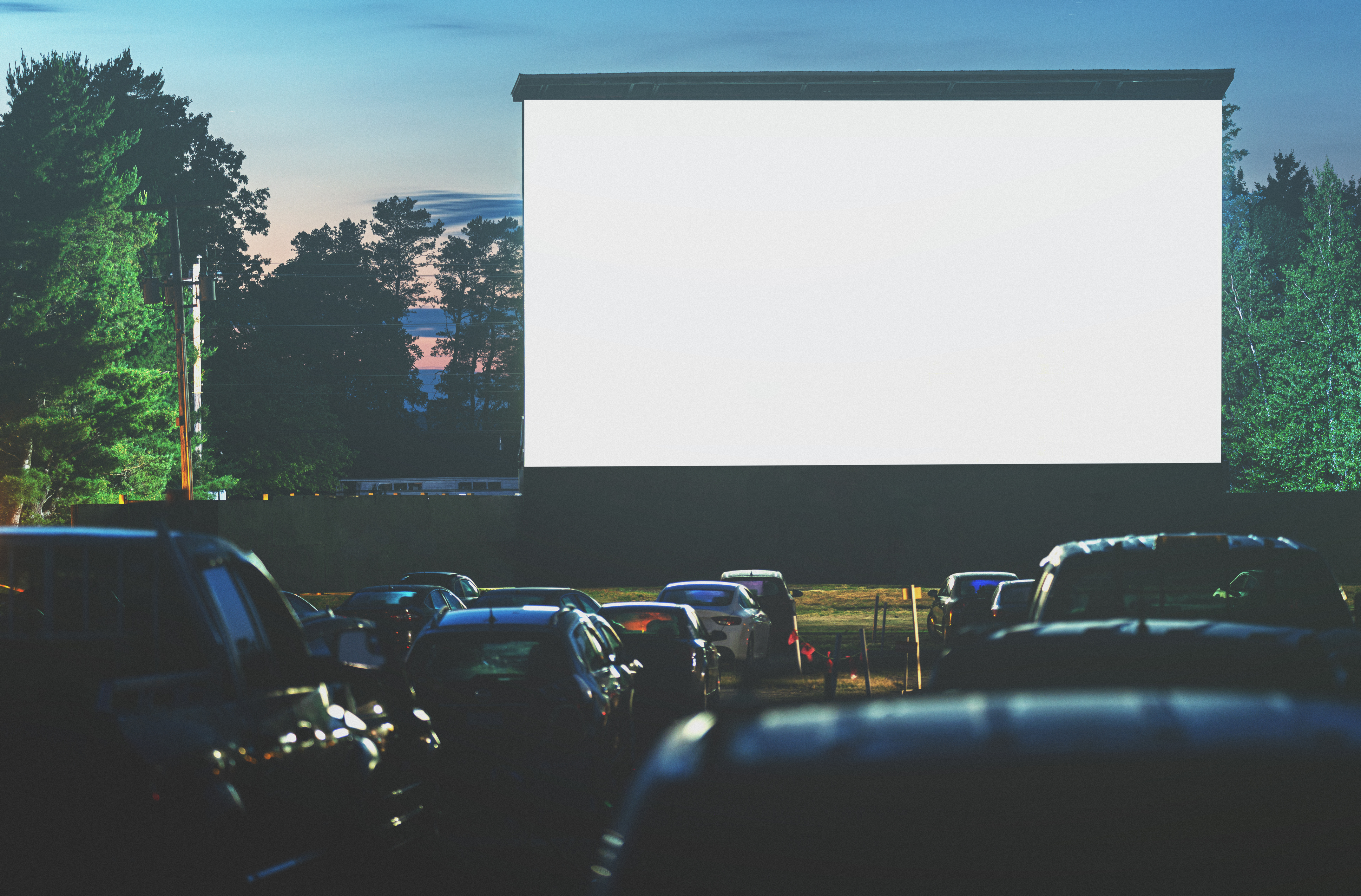 Movie goers enjoy a drive in movie for the first time in 2020. Long exposure.