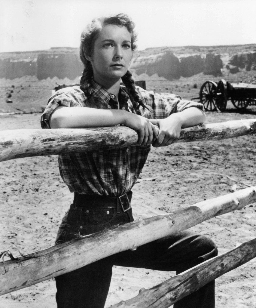 Vera Miles holds onto a wooden fence in a scene from the film 'The Searchers', 1956.