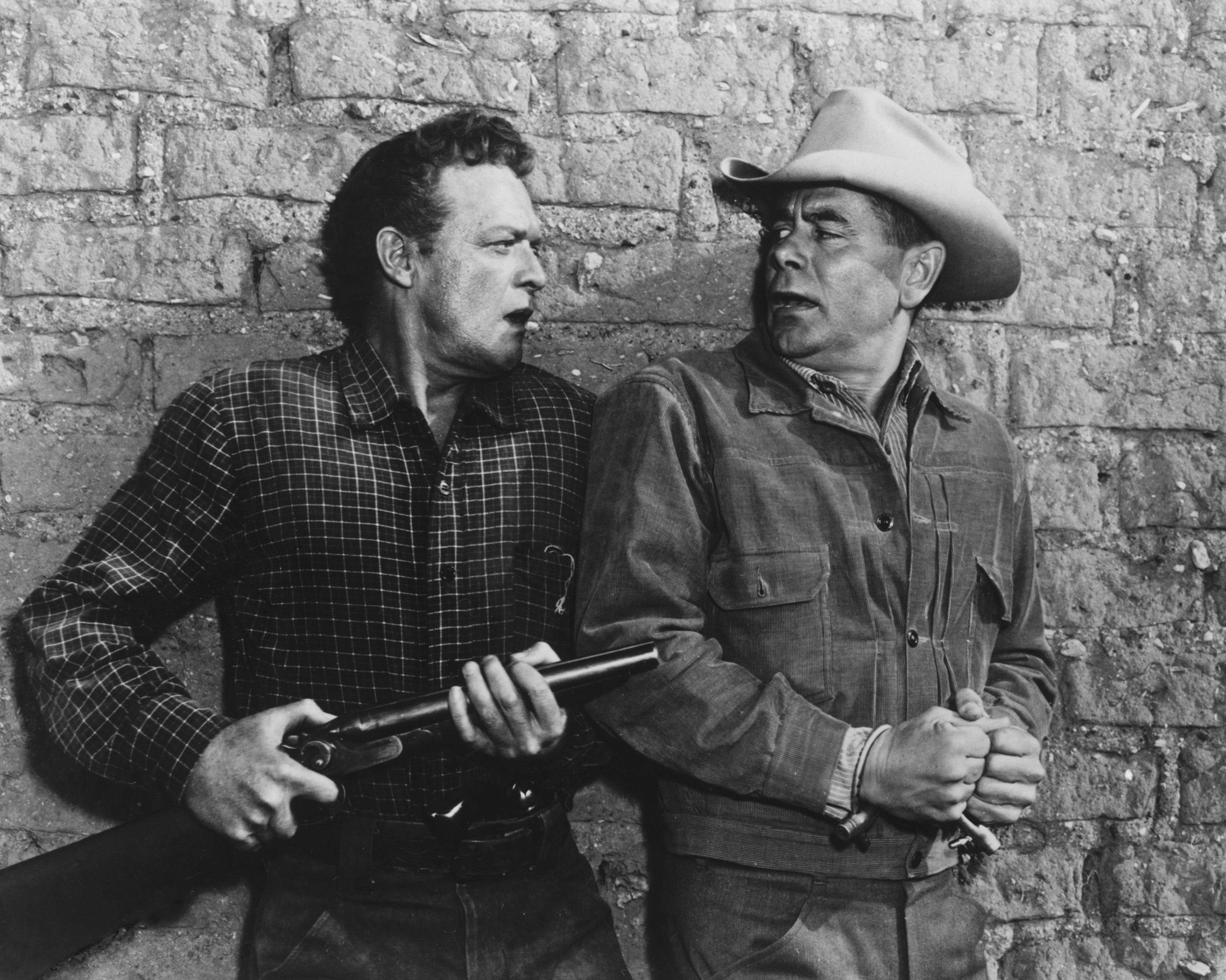 American actor Van Heflin (1910 - 1971, left) as Dan Evans, and Canadian-born American actor Glenn Ford (1916 - 2006) as Ben Wade in '3:10 To Yuma', directed by Delmer Daves, 1957. 