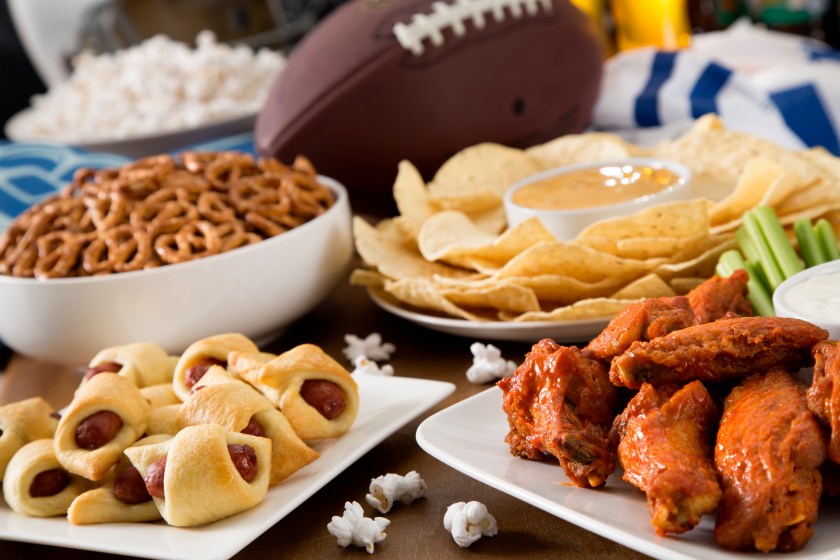 Hot wings, nachos, pigs in a blanket, beer, and popcorn, a tailgate party spread. Please see my portfolio for other food and drink images.