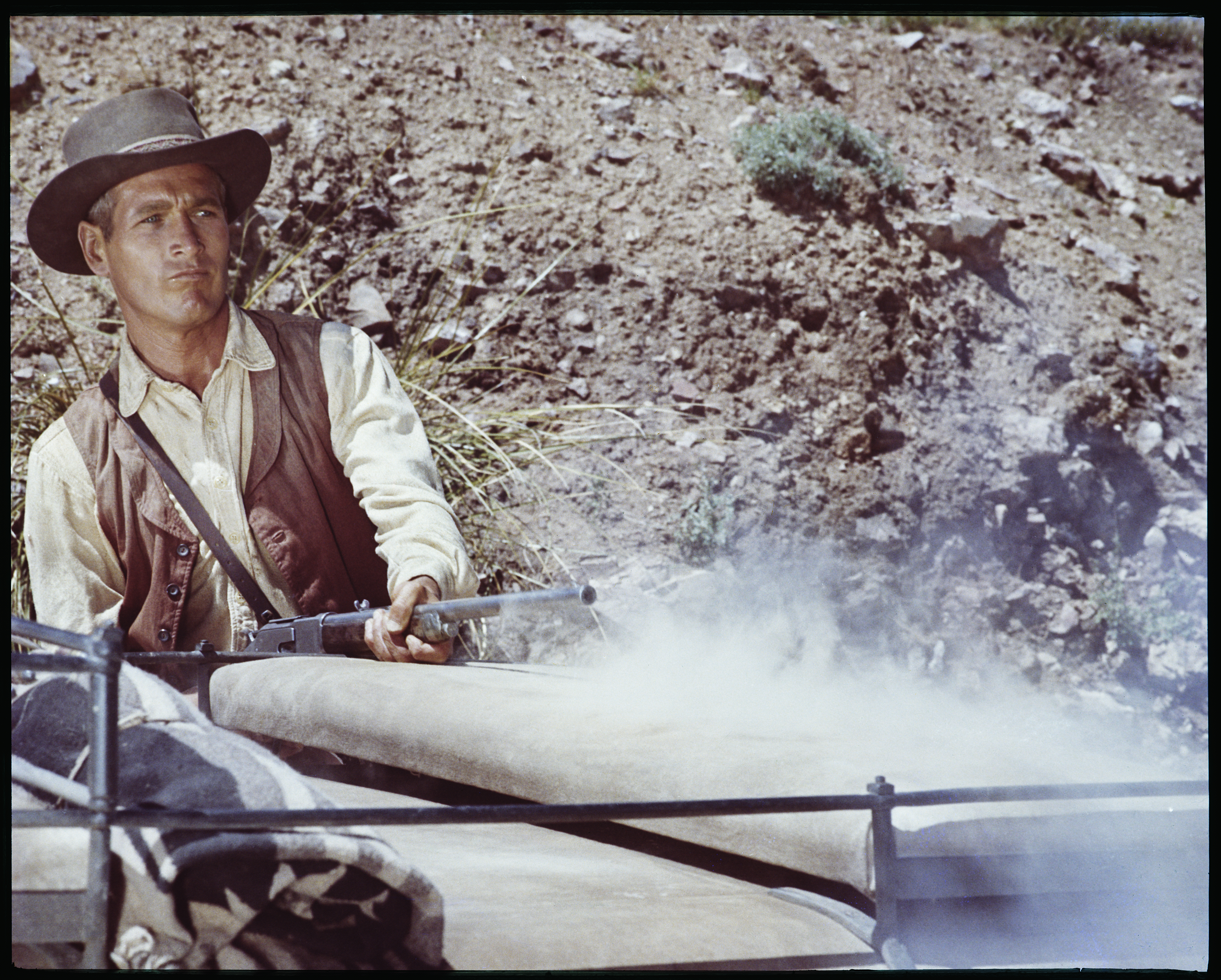 UNITED STATES - CIRCA 1967:  Paul Newman plays John "Hombre" Russell, the only hope of a group of stagecoach passengers set upon by bandits in the movie "Hombre", 1967. Newman is seen firing his rifle at the bandits.