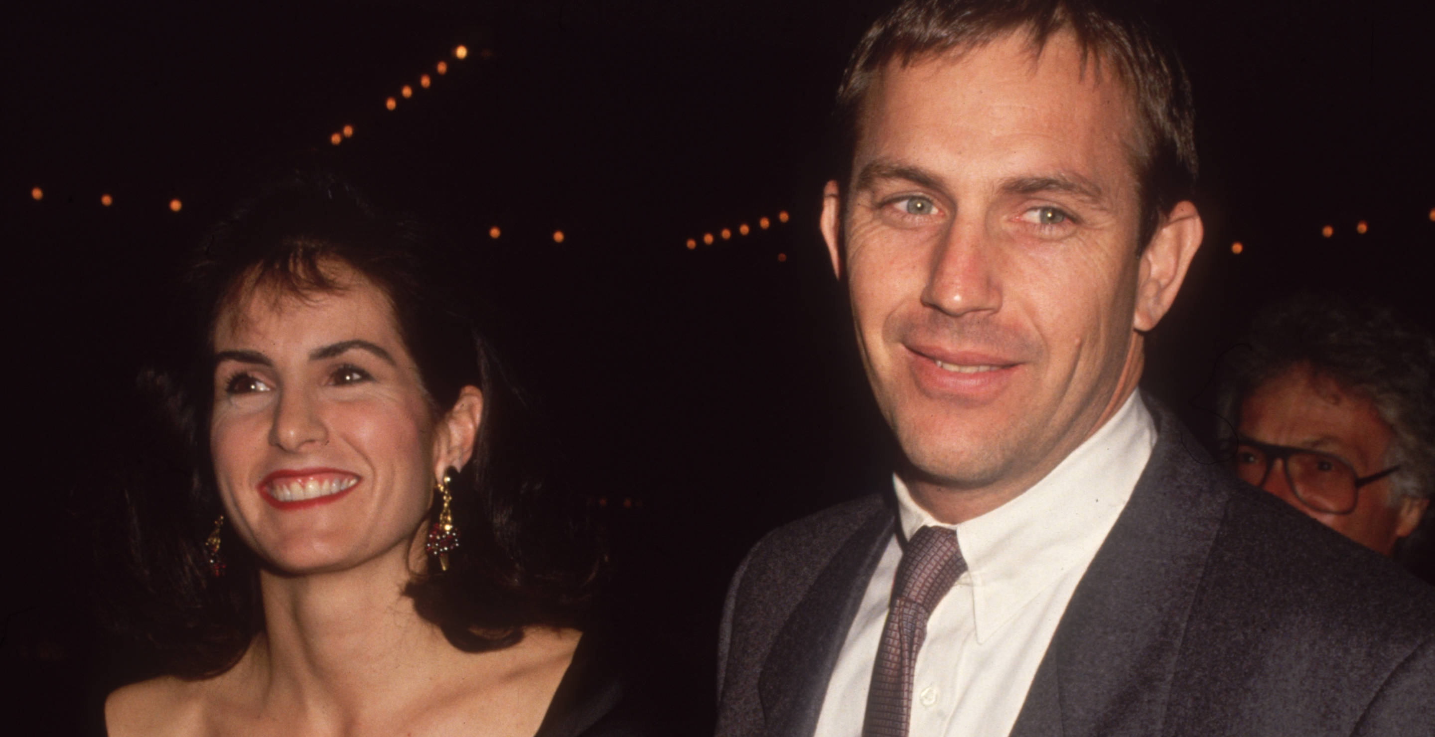 Kevin Costner and his wife, Cindy Silva, smile while arriving at a semiformal event