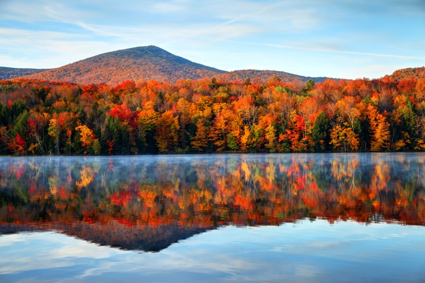Early morning autumn light near Killington, Vermont. Photo taken on a calm tranquil colorful morning during the peak autumn foliage season. Vermont's beautiful fall foliage ranks with the best in New England bringing out some of the most colorful foliage in the United States