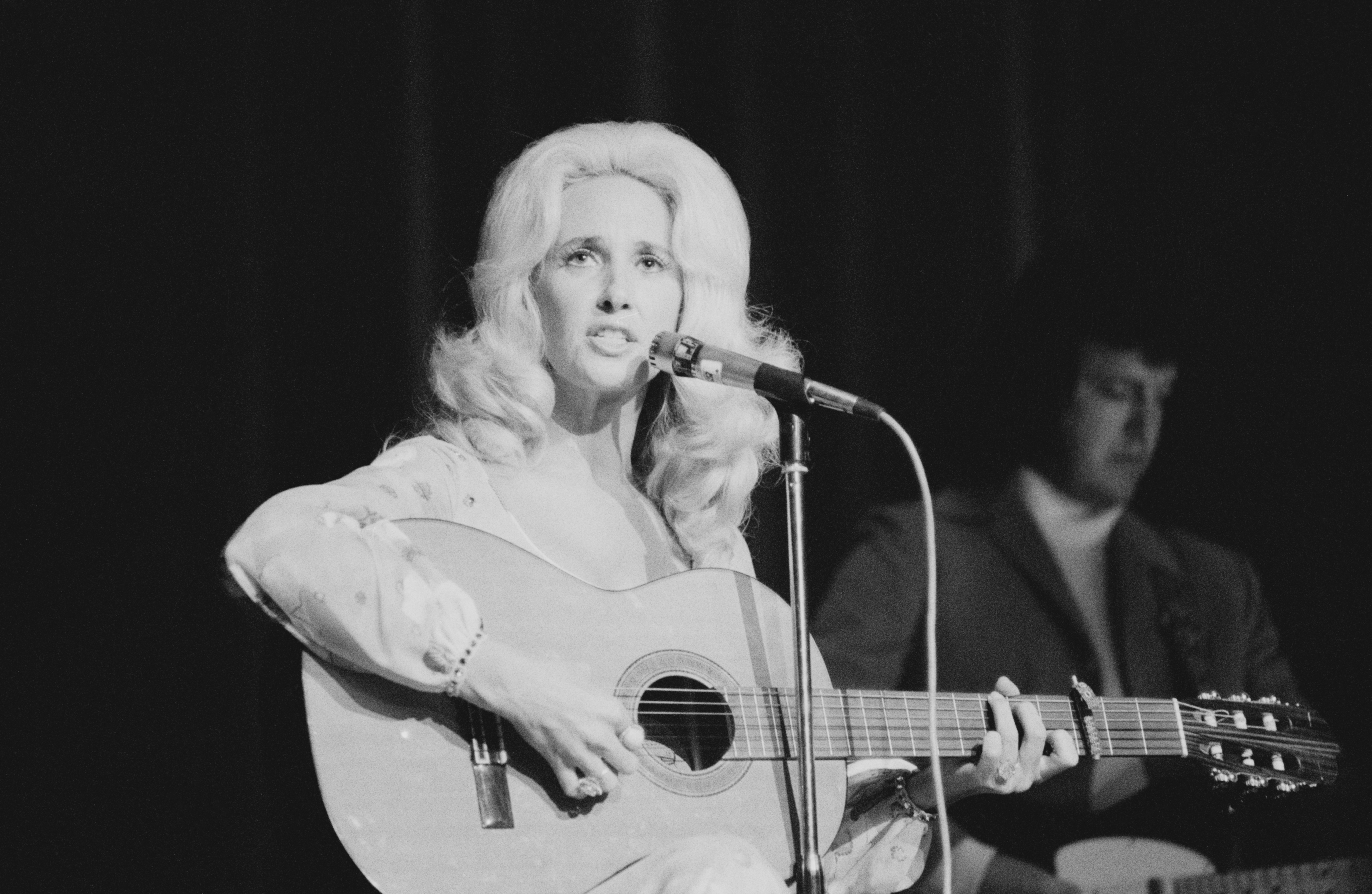 American country music singer-songwriter Tammy Wynette (1942 - 1998) performing at the Hammersmith Odeon, London, June 1975.