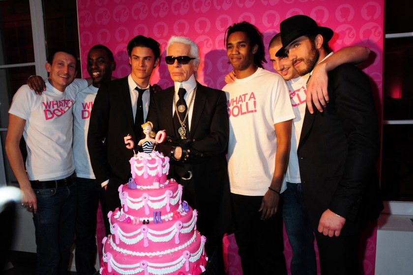 PARIS, FRANCE - MARCH 12: Top Model Baptiste Giabiconi ( Who posed for Karl Lagerfeld as Ken in black Tie ) , Fashion Designer Karl Lagerfeld, his Secretary Model Sebastien Jondeau ( Hat ) and Waiters in White Tee-Shirts attend the Barbie 50th Anniversary: Karl Lagerfeld Exhibition Preview Cocktail at Colette's Shop Gallery on March 12, 2009 in Paris, France.