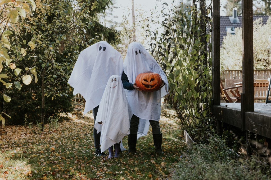 Family spending Halloween together and playing trick or treat.