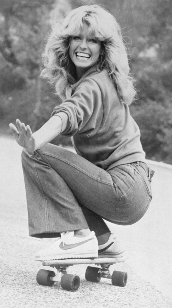 Actress Farrah Fawcett, wearing jeans, sweatshirt and Nike athletic shoes, practices skateboarding for an episode of Charlie's Angels.
