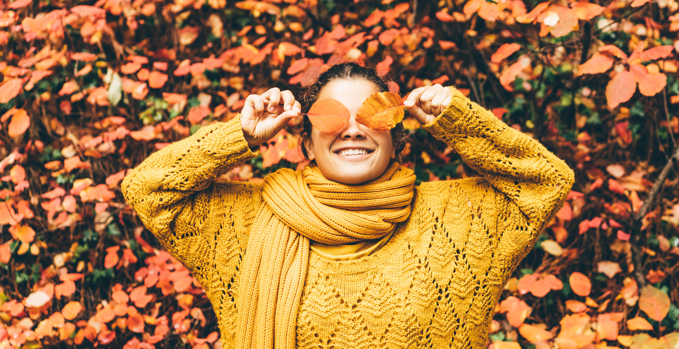 woman laying in leaves