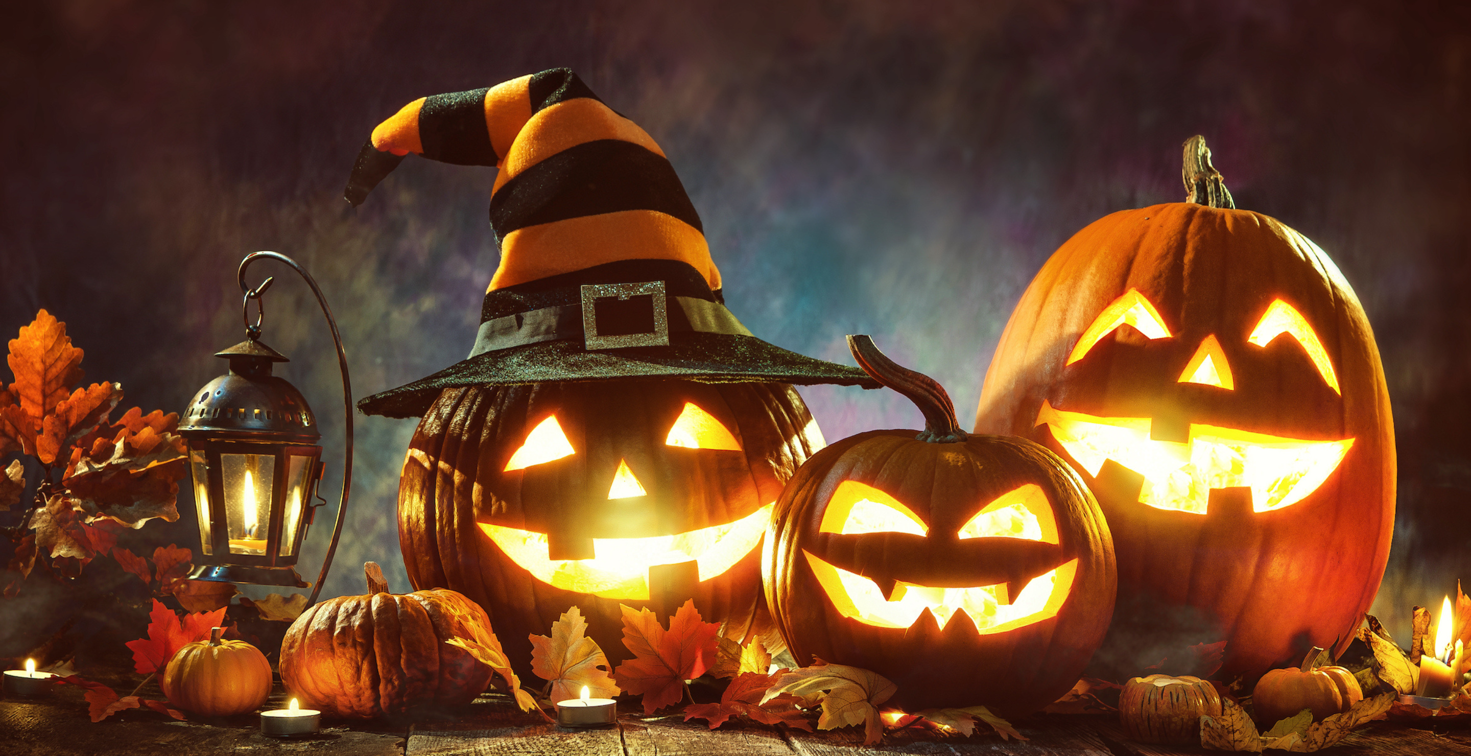 Three jack-o-lanterns lit up at night