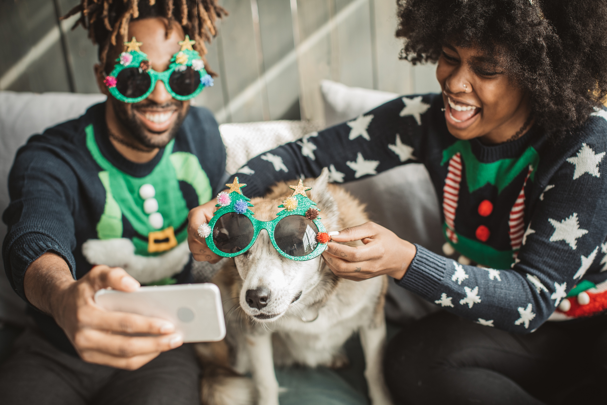 Couple and dog taking Christmas photos