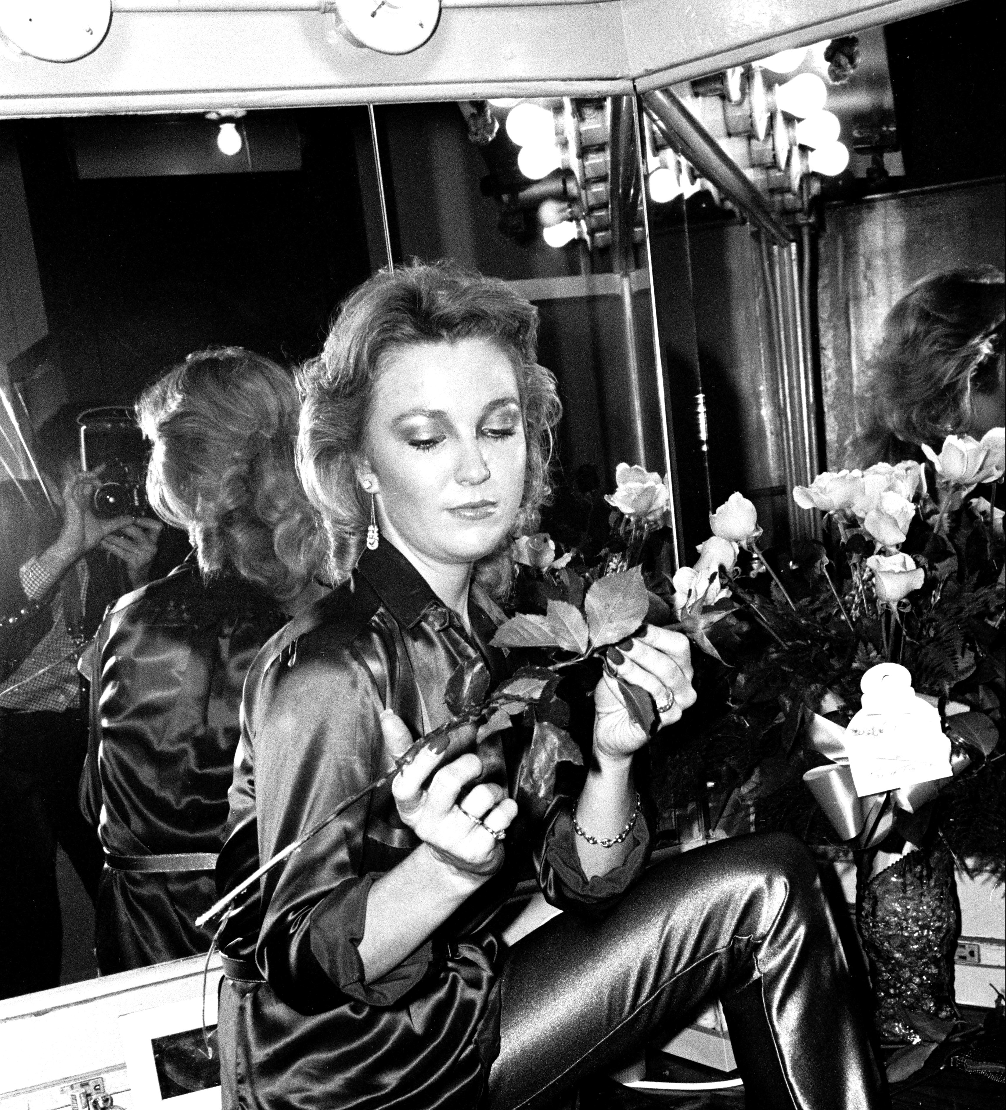 Portrait of American Country musician Tanya Tucker, a bouquet roses in her hands, as she poses backstage prior to a performance at the Bottom Line, New York, New York, December 13, 1987. Tucker was performing in support of her 'TNT' album. 