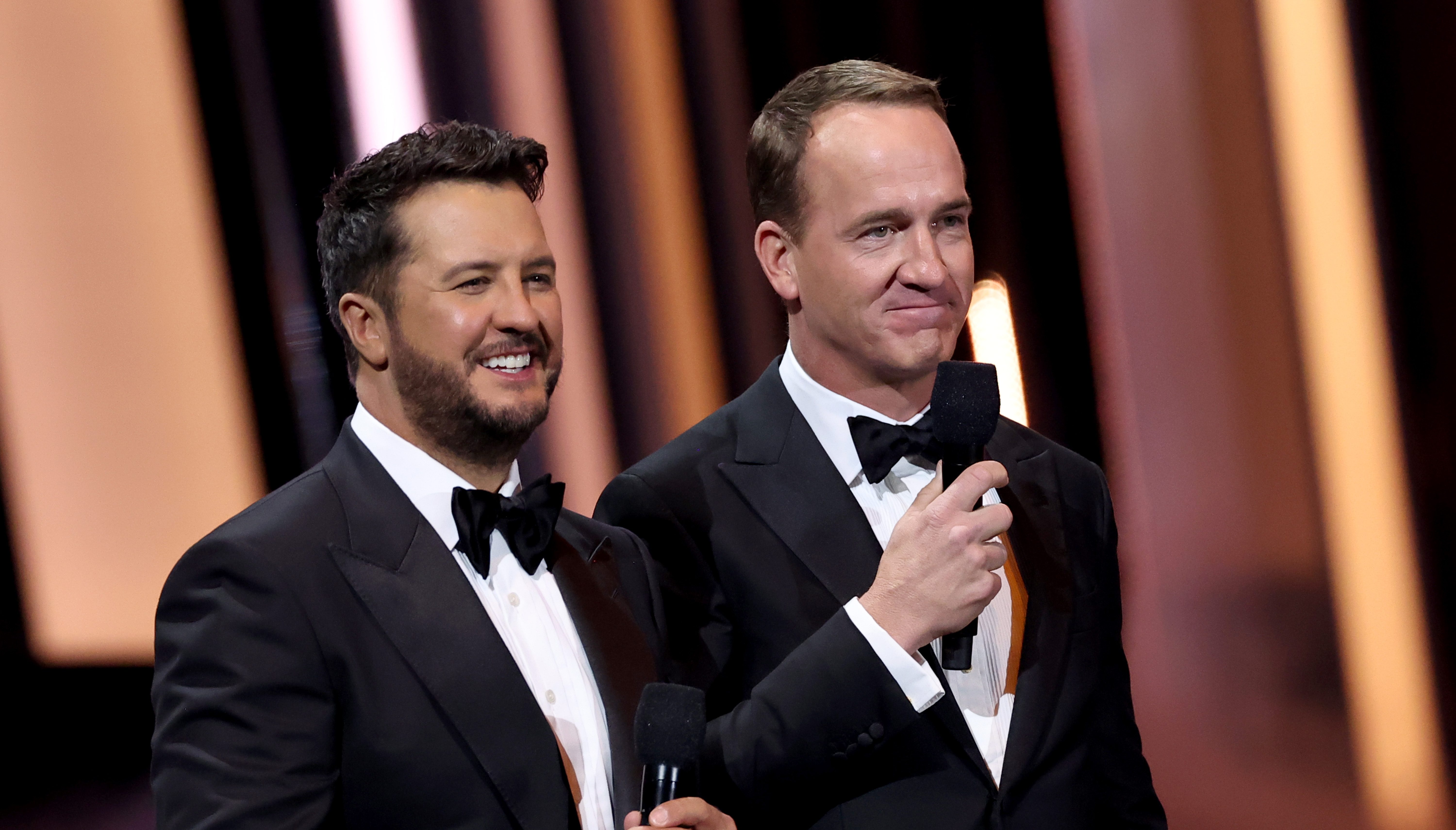 NASHVILLE, TENNESSEE - NOVEMBER 09: Hosts Luke Bryan and Peyton Manning speak onstage at The 56th Annual CMA Awards at Bridgestone Arena on November 09, 2022 in Nashville, Tennessee.