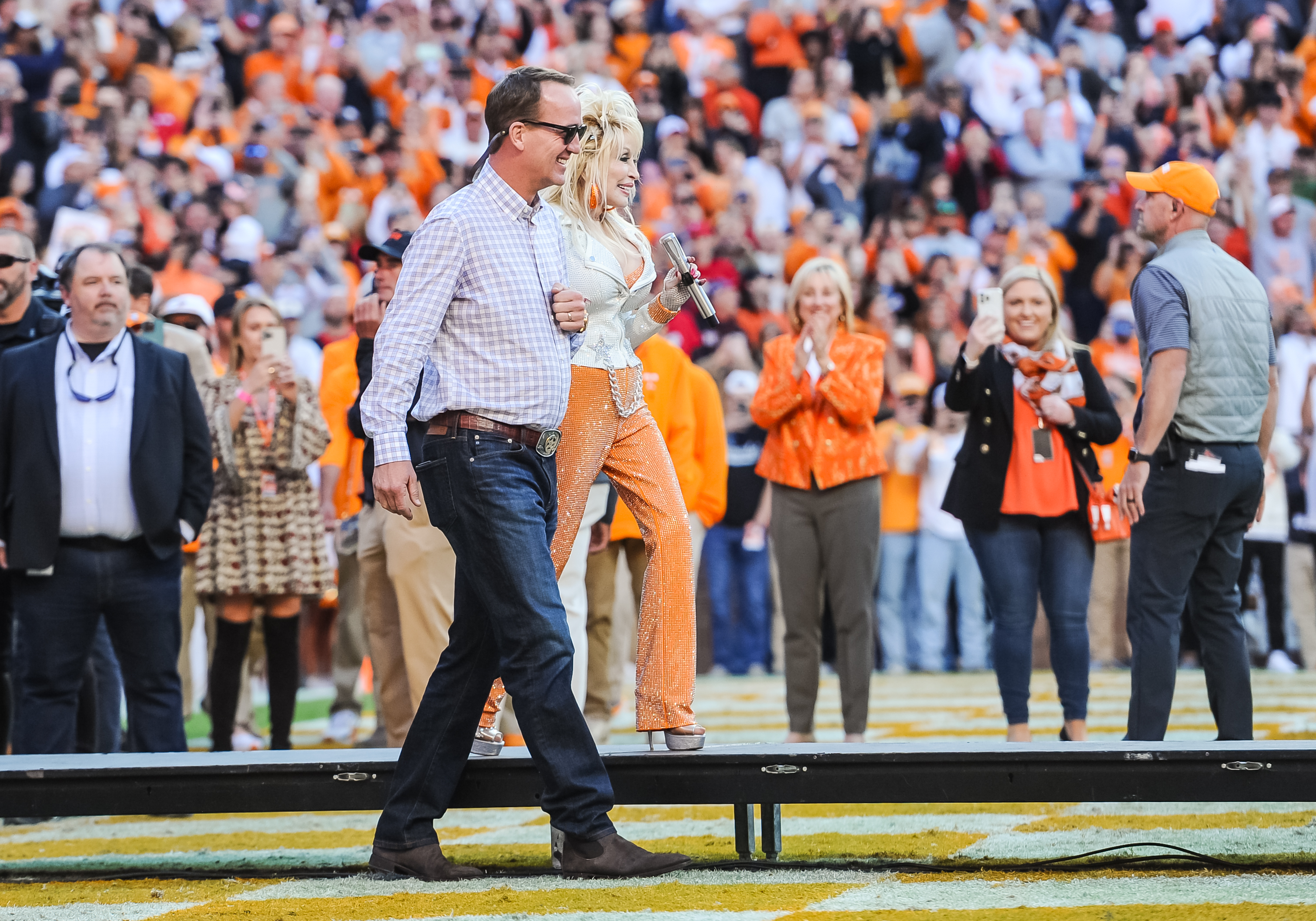 KNOXVILLE, TN - NOVEMBER 18: Peyton Manning walks with Dolly Parton during a college football game between the Tennessee Volunteers and the Georgia Bulldogs on November 18, 2023, at Neyland Stadium, in Knoxville, TN. 
