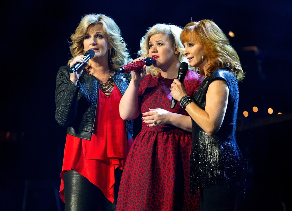 Trisha Yearwood, Kelly Clarkson, and Reba McEntire perform during Kelly Clarkson Miracle On Broadway.
