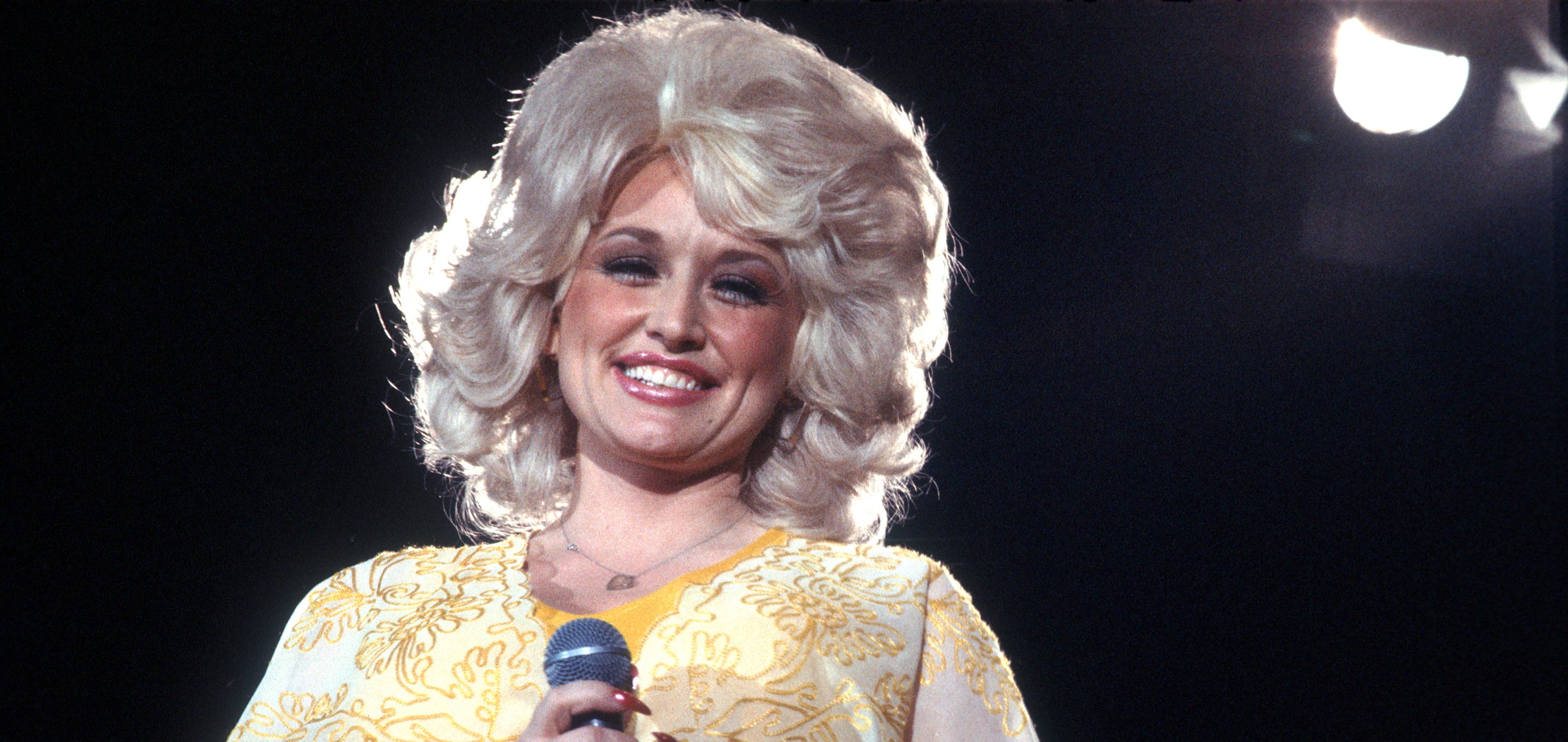 LOS ANGELES - CIRCA 1975: Country singer Dolly Parton performs onstage wearing a yellow dress, circa 1975, Los Angeles, California.