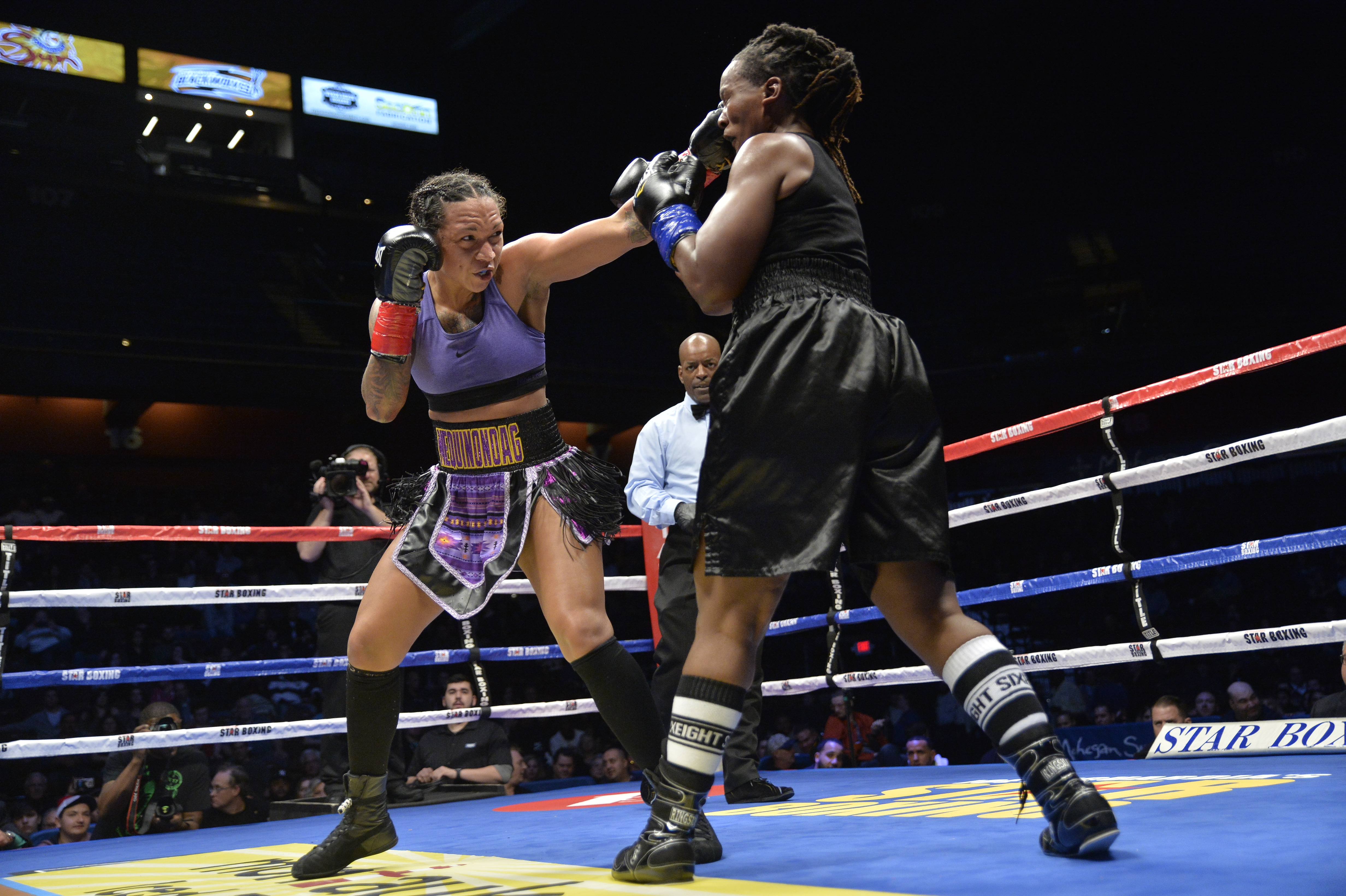 UNCASVILLE, CT - NOVEMBER 25: Kali Reis (red tape) takes on Tiffany Woodard (blue tape) in a Middleweight bout on November 25, 2017 at the Mohegan Sun Arena in Uncasville, Connecticut. Kali Reis defeats Tiffany Woodard via decision.