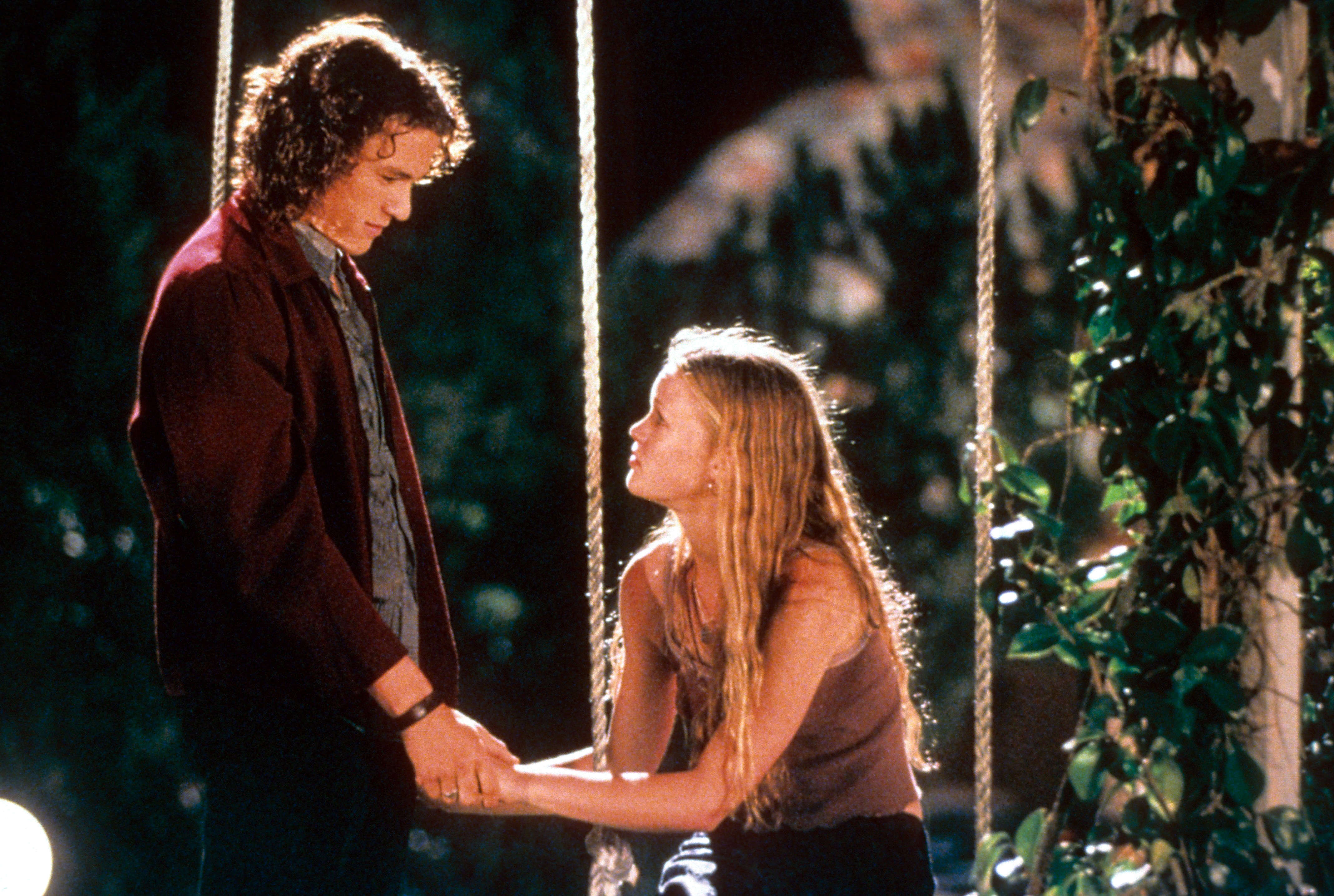 Heath Ledger and Julia Stiles at swing in a scene from the film '10 Things I Hate About You', 1999. 