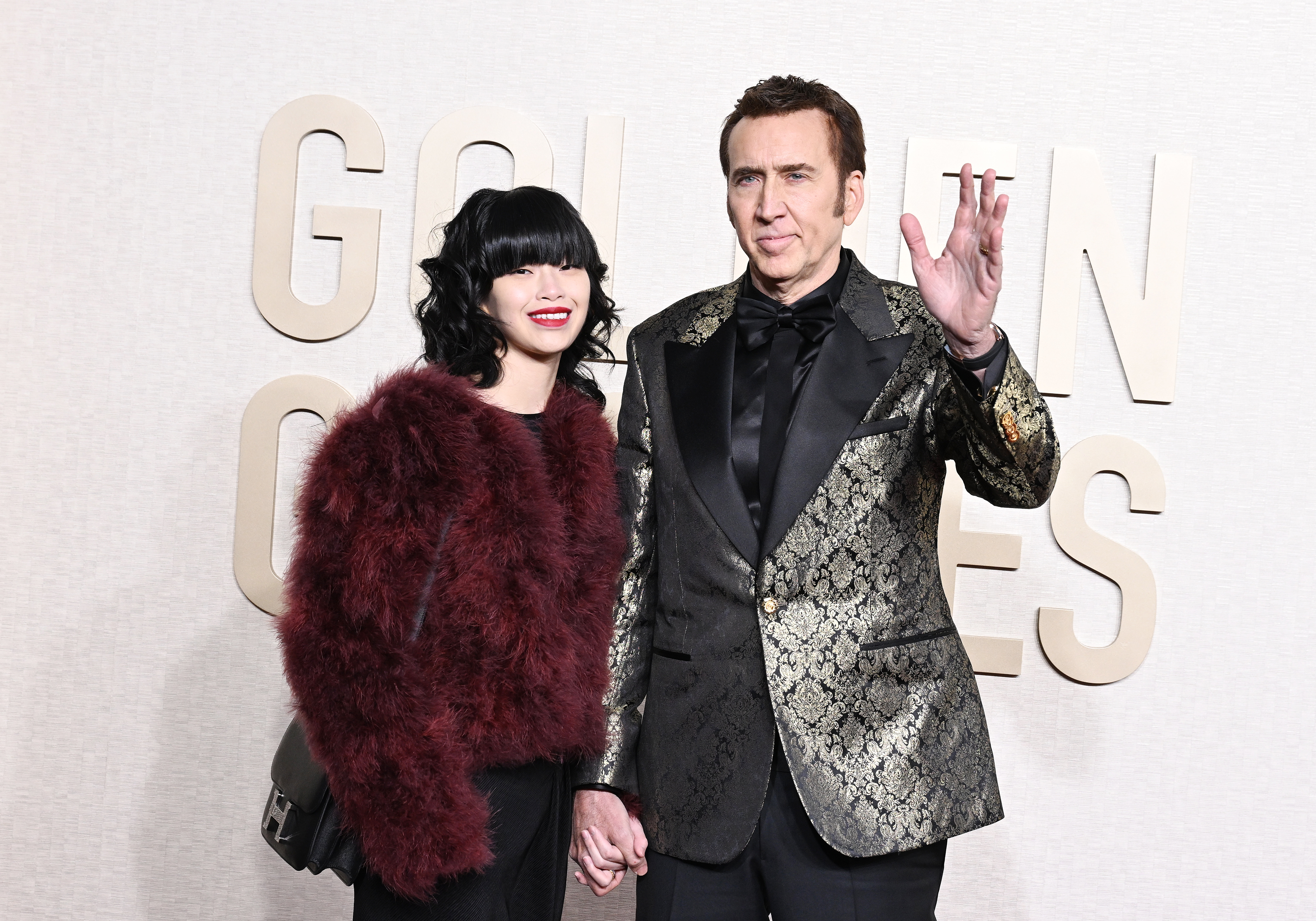 Riko Shibata and Nicolas Cage at the 81st Golden Globe Awards held at the Beverly Hilton Hotel on January 7, 2024 in Beverly Hills, California