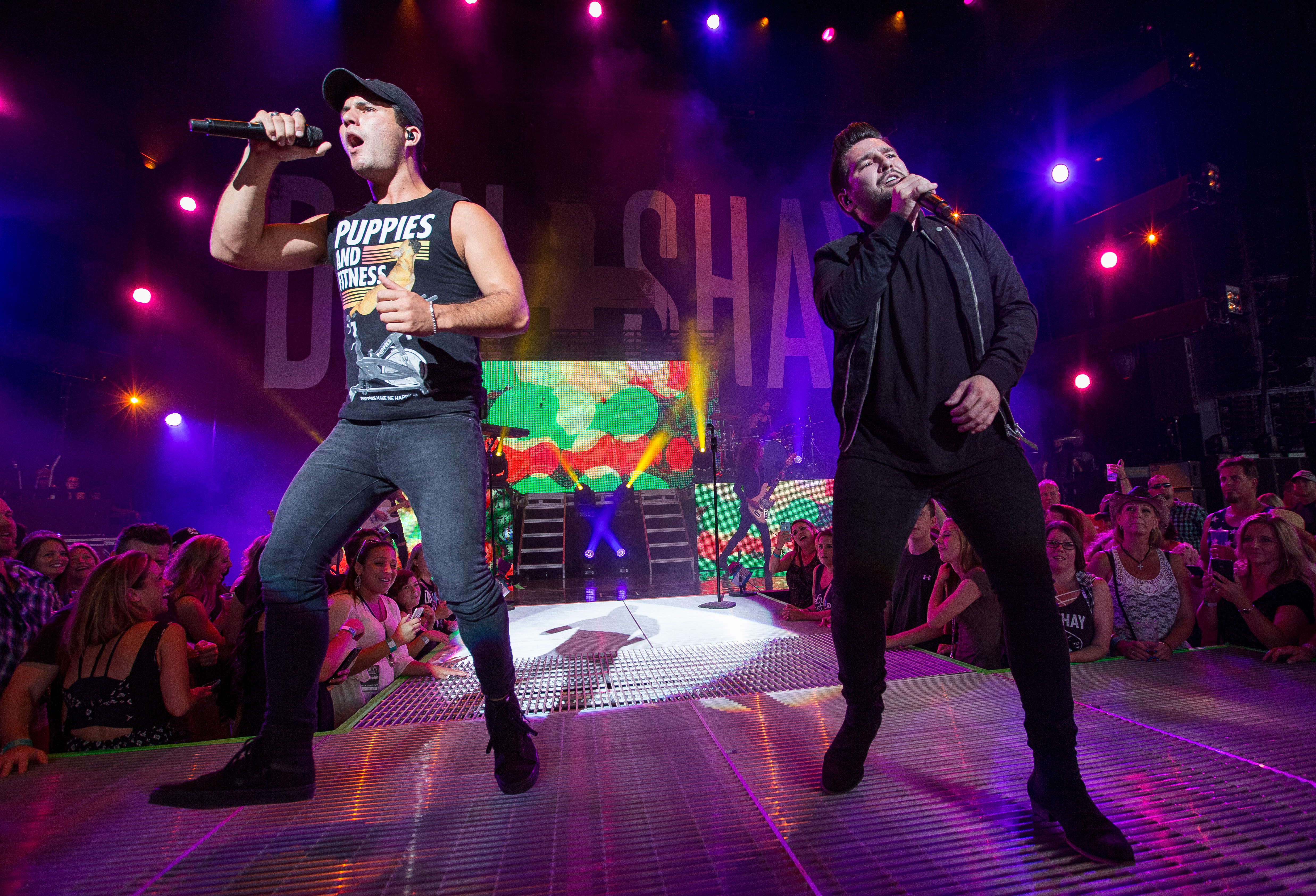 CLARKSTON, MI - AUGUST 25: Dan Smyers (L) and Shay Mooney of country music duo Dan + Shay perform in support of the Good For a Good Time Tour 2016 at DTE Energy Music Theater on August 25, 2016 in Clarkston, Michigan. 