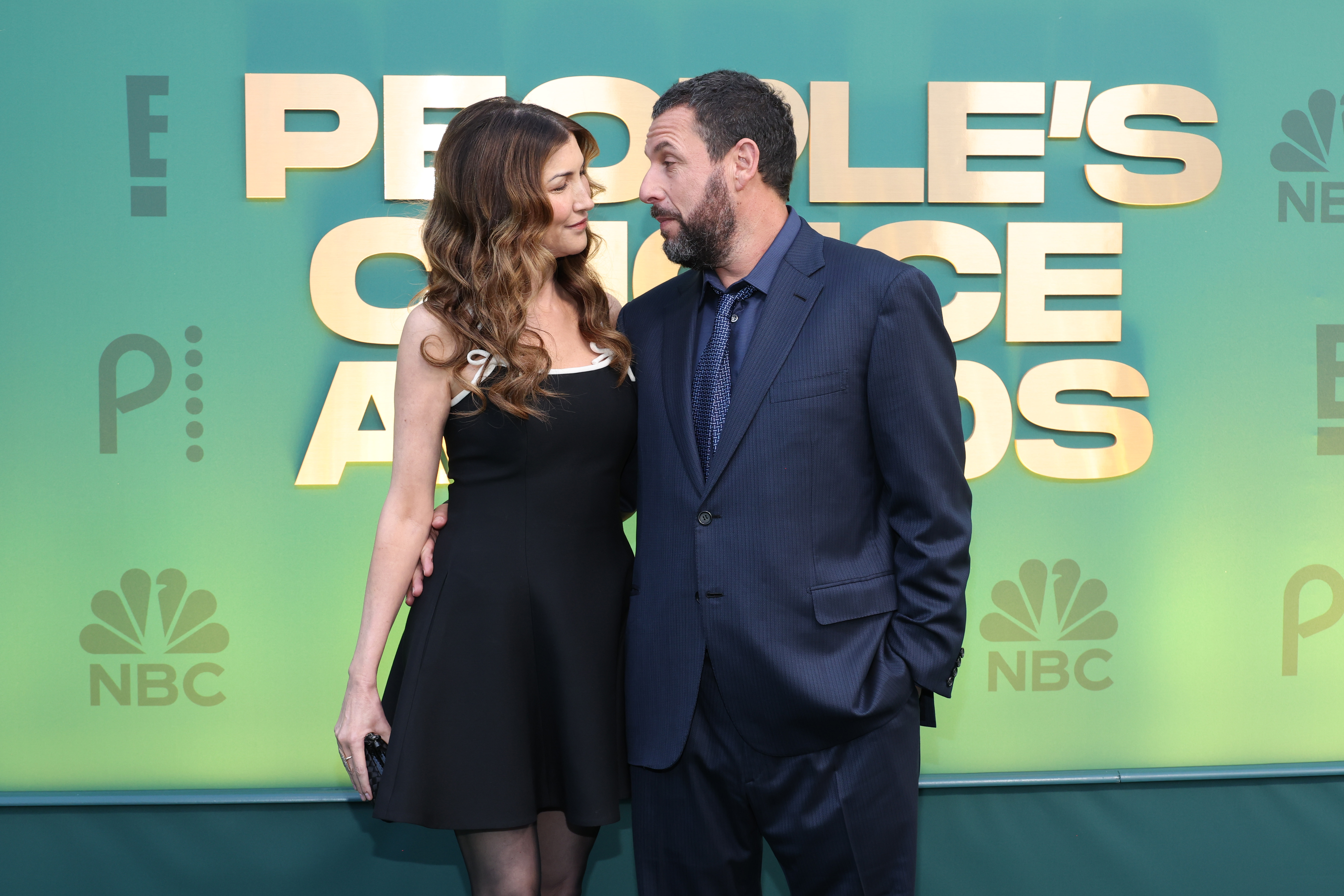 SANTA MONICA, CALIFORNIA - FEBRUARY 18: (L-R) Jackie Sandler and Adam Sandler attend the 2024 People's Choice Awards at Barker Hangar on February 18, 2024 in Santa Monica, California.