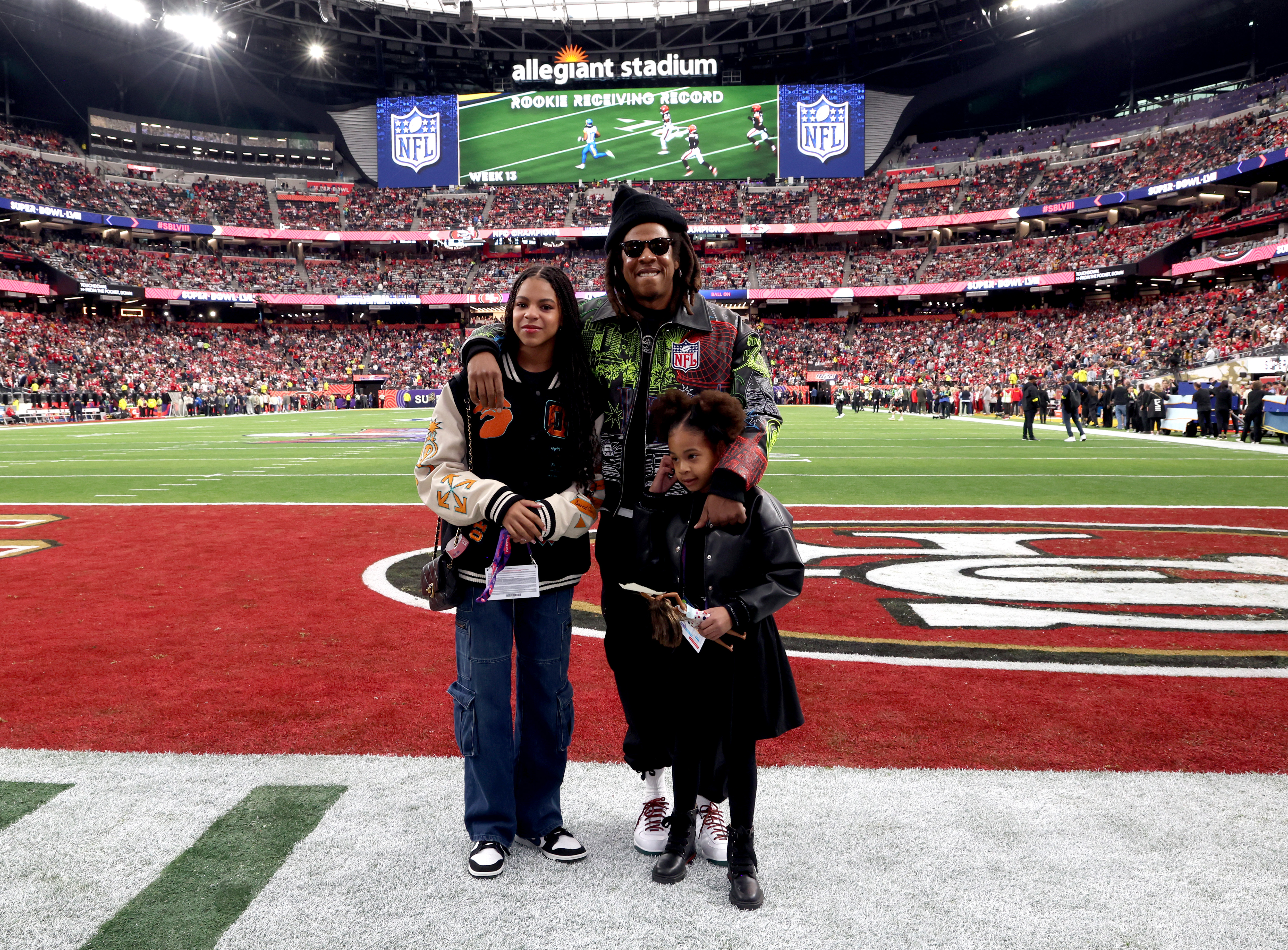 LAS VEGAS, NEVADA - FEBRUARY 11: (L-R) Blue Ivy Carter, Jay-Z and Rumi Carter attend the Super Bowl LVIII Pregame at Allegiant Stadium on February 11, 2024 in Las Vegas, Nevada.