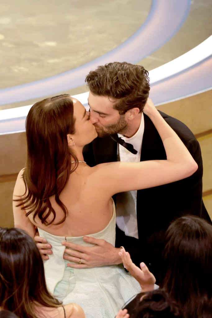 HOLLYWOOD, CALIFORNIA - MARCH 10: Emma Stone and Dave McCary kiss as she is announced Lead Actress award winner for "Poor Things" during the 96th Annual Academy Awards at Dolby Theatre on March 10, 2024 in Hollywood, California.