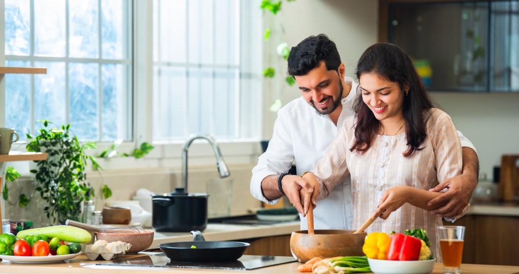 a couple cooking together romantically in the kitchen 