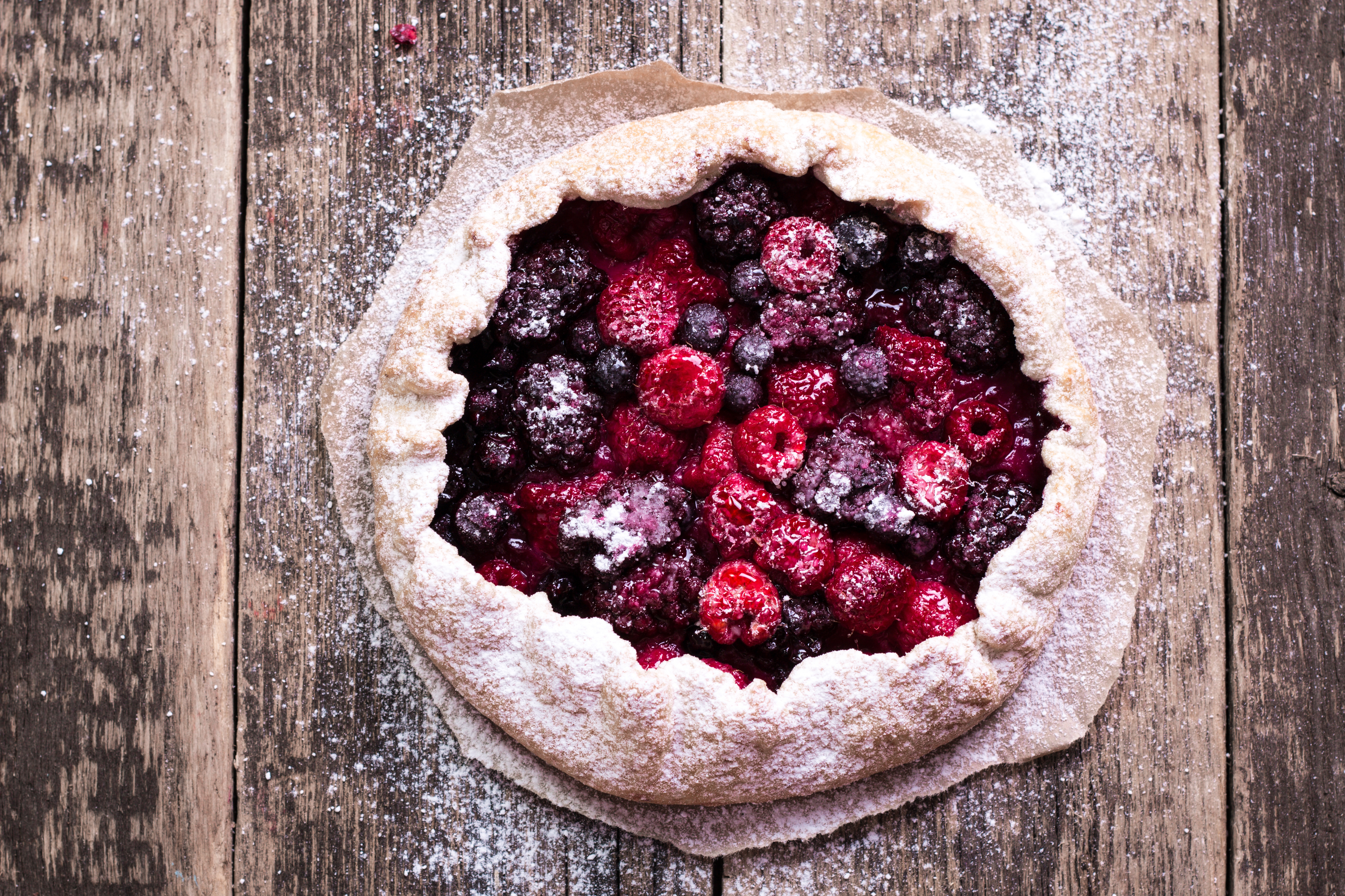 Blueberry,cherry,raspberry and blackcurrant galette on w wooden background.