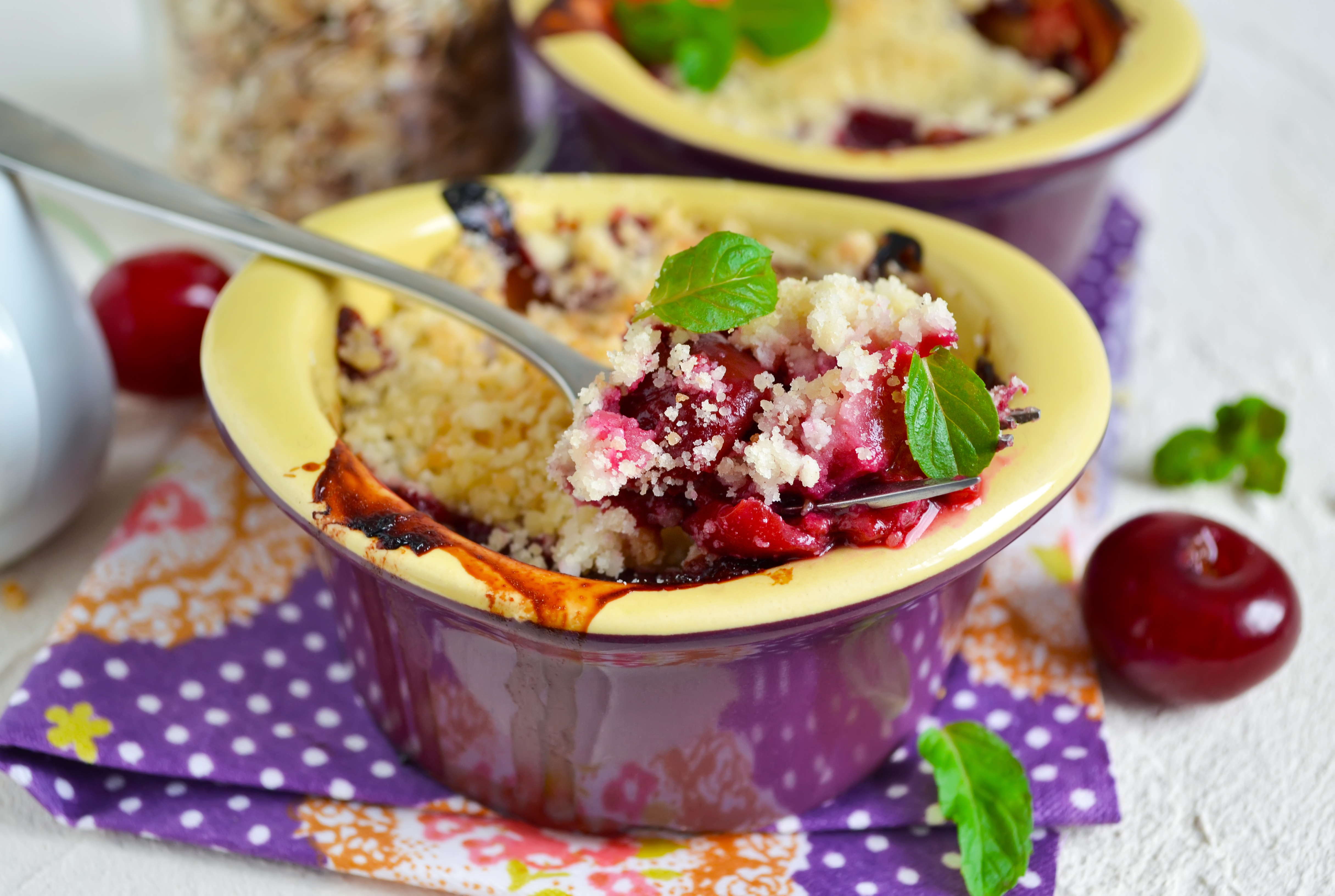 Cherry crumble with porridge on a concrete background