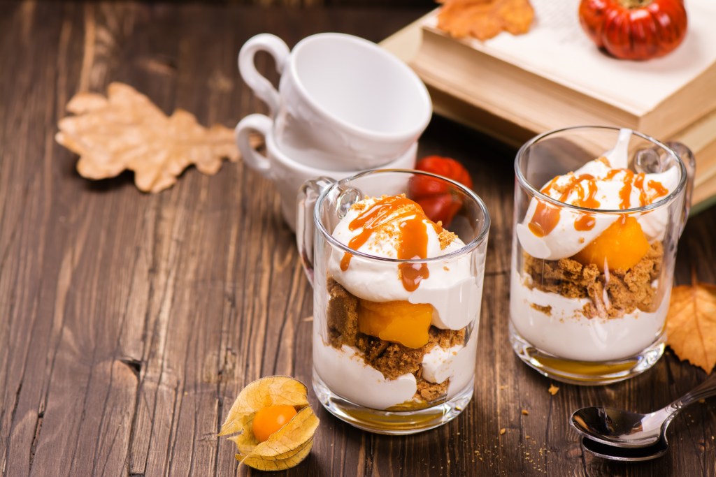 Layered "pumpkin pie" in a glass cup. Pumpkin tiramissu. Vintage style. Selective focus