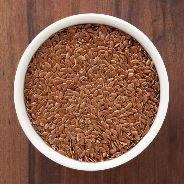 Top view of white bowl full of flax seeds