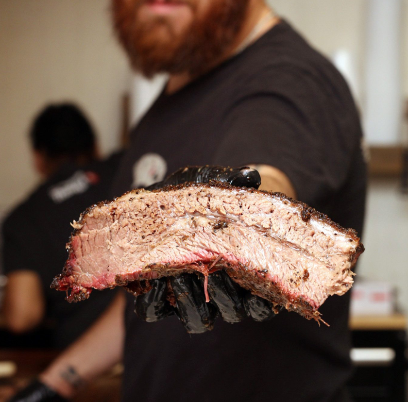 man holding BBQ