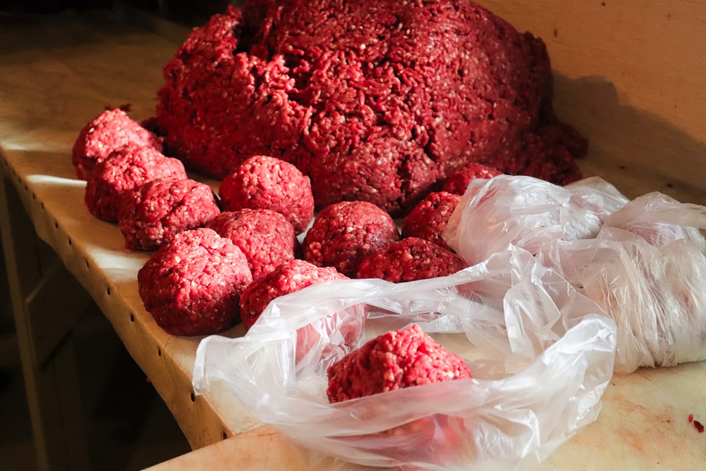 Piles of rounded ground meat ready for packaging.