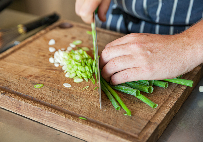 Man chopping scallions