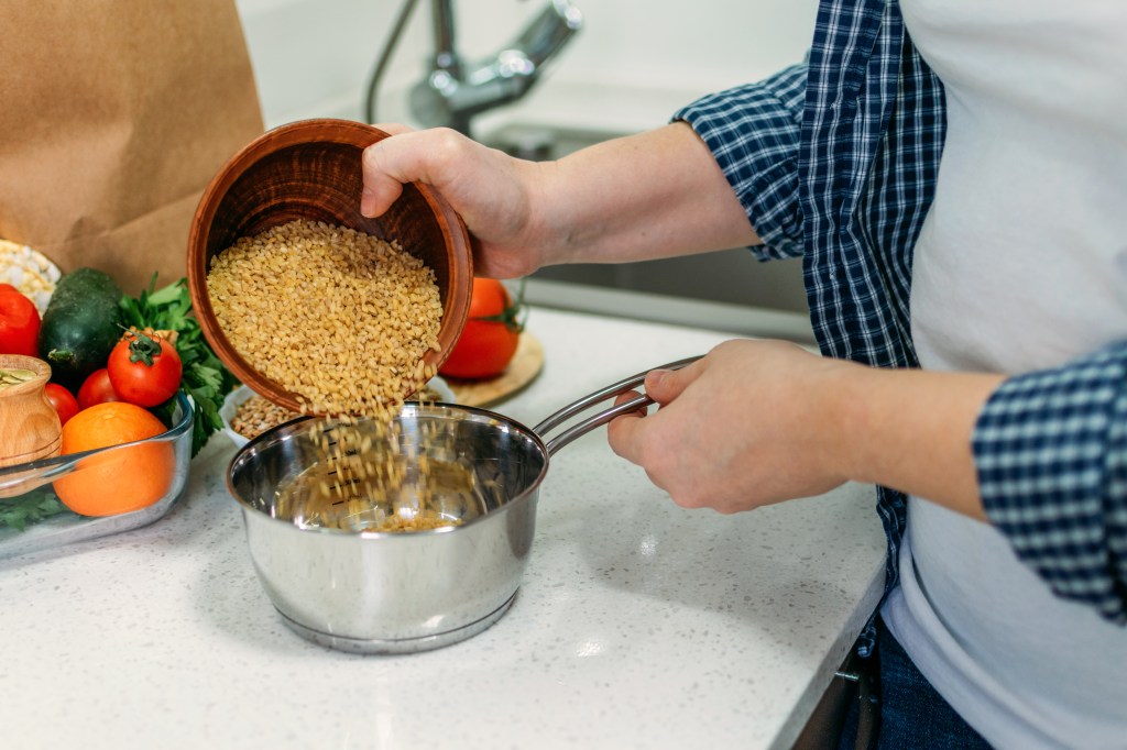 Woman is cooking Ancient Grains Porridge.