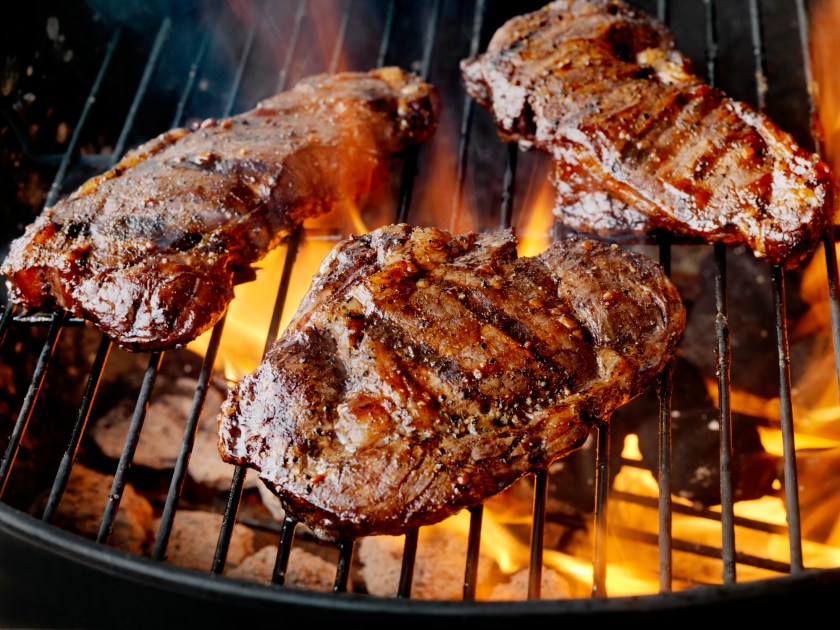 Steaks seasoned with salt and pepper on an outdoor grill -Photographed on Hasselblad H3-22mb Camera