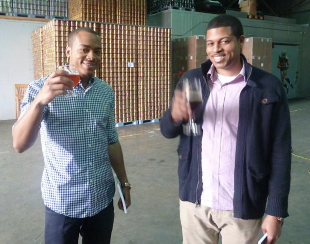Two Men Drinking Beers From Cajun Fire