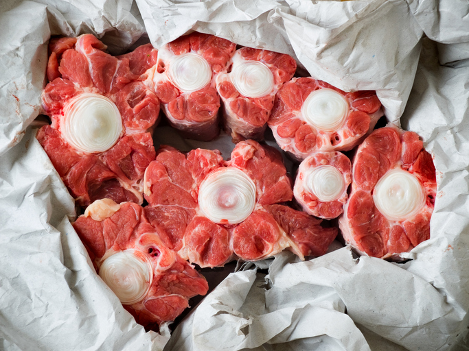 Bull tail in raw from the market wrapped in paper.