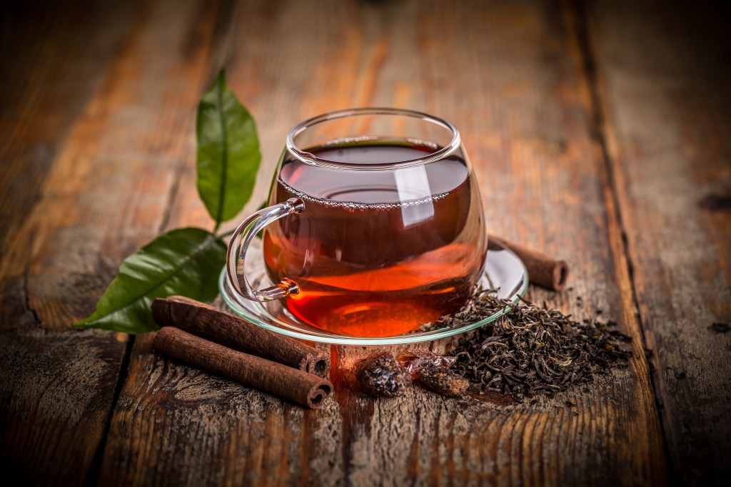 Cup of green tea on a wooden table