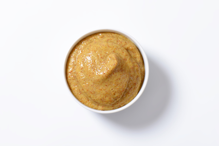 bowl of mustard isolated on white background