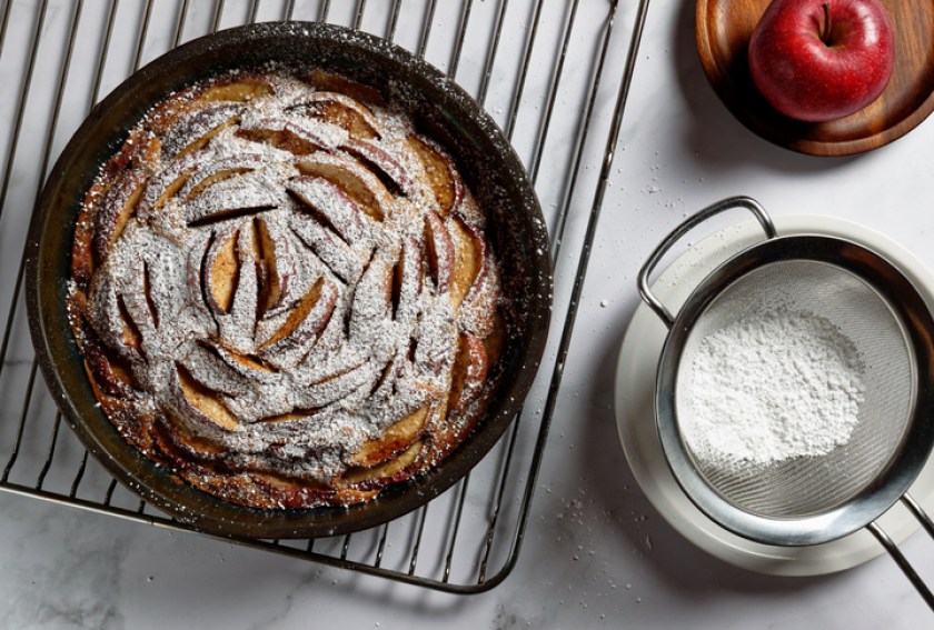 Homemade apple pie on an oven rack, in a silicone baking dish.