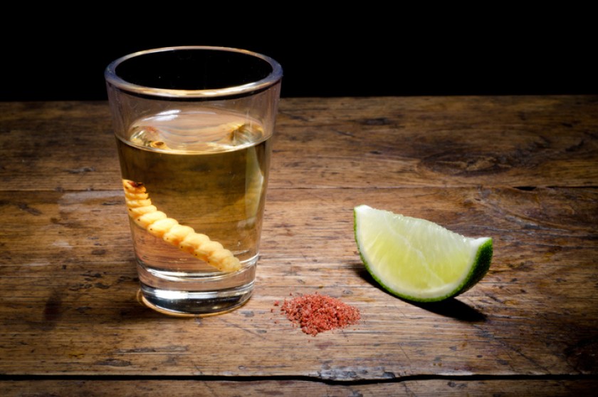 Tequila shot with lime and salt on vintage background.