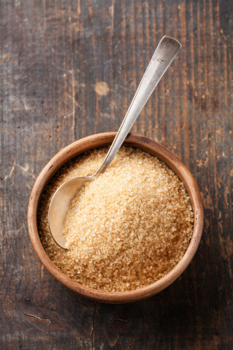 Brown sugar on wooden background