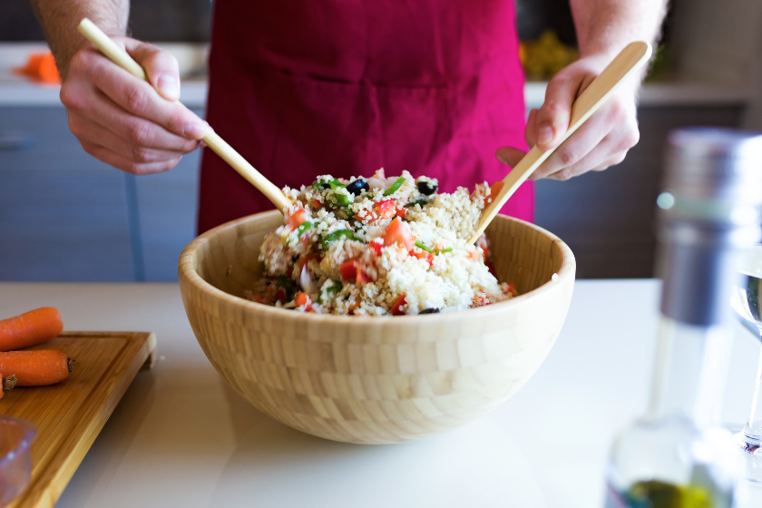 man tossing quinoa