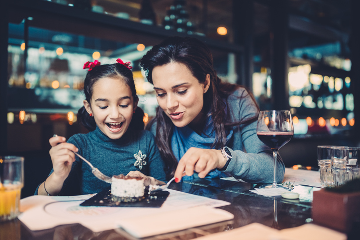 Mother and her daughter eating lunch in gourmet restaurant