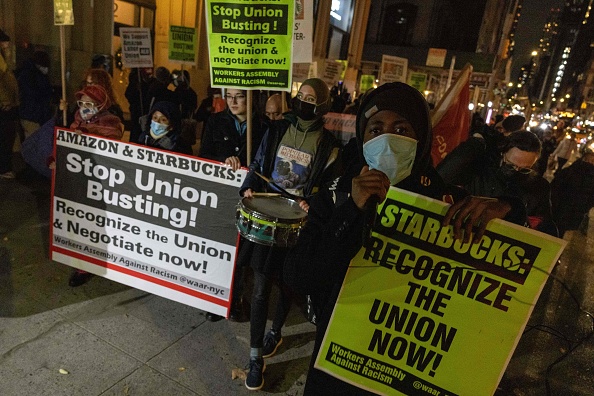 People march during a protest in support of Amazon and Starbucks workers in New York City on November 26, 2021. 