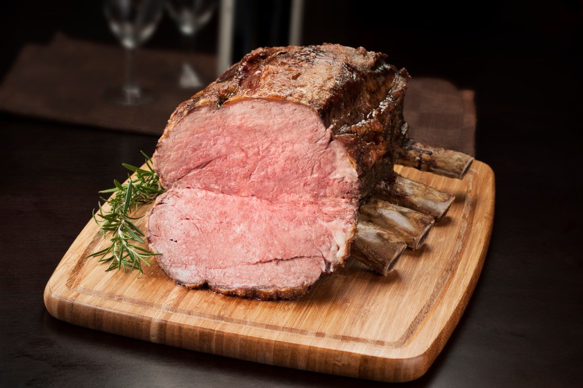 Prime rib roast on a cutting board ready to be sliced