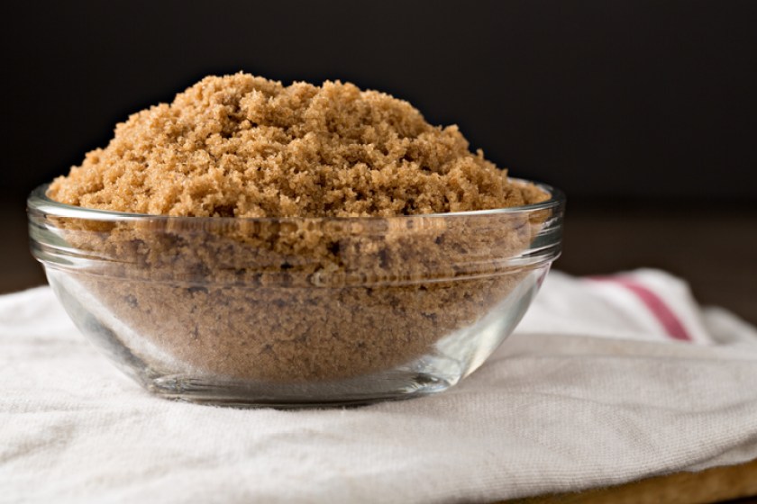 Bowl Of Brown Sugar On White Tea Towel